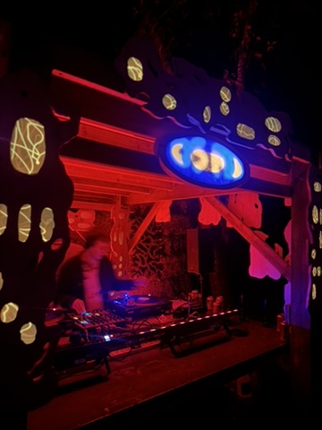 Osmosis in the Trees 2025 - Forest stage, red-lit DJ booth