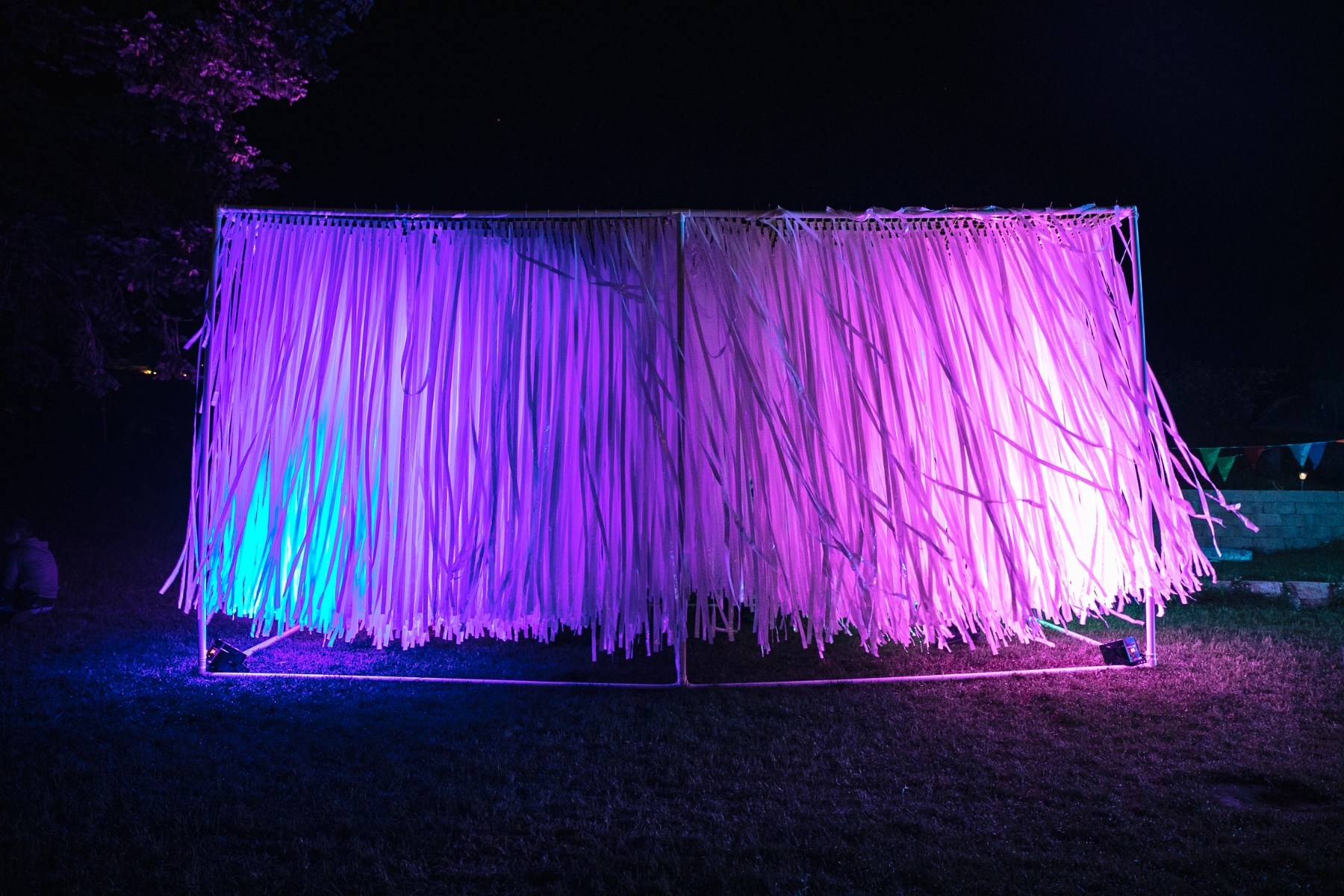 Fete - Spaghetti Warehouse - lit streamer wall at night